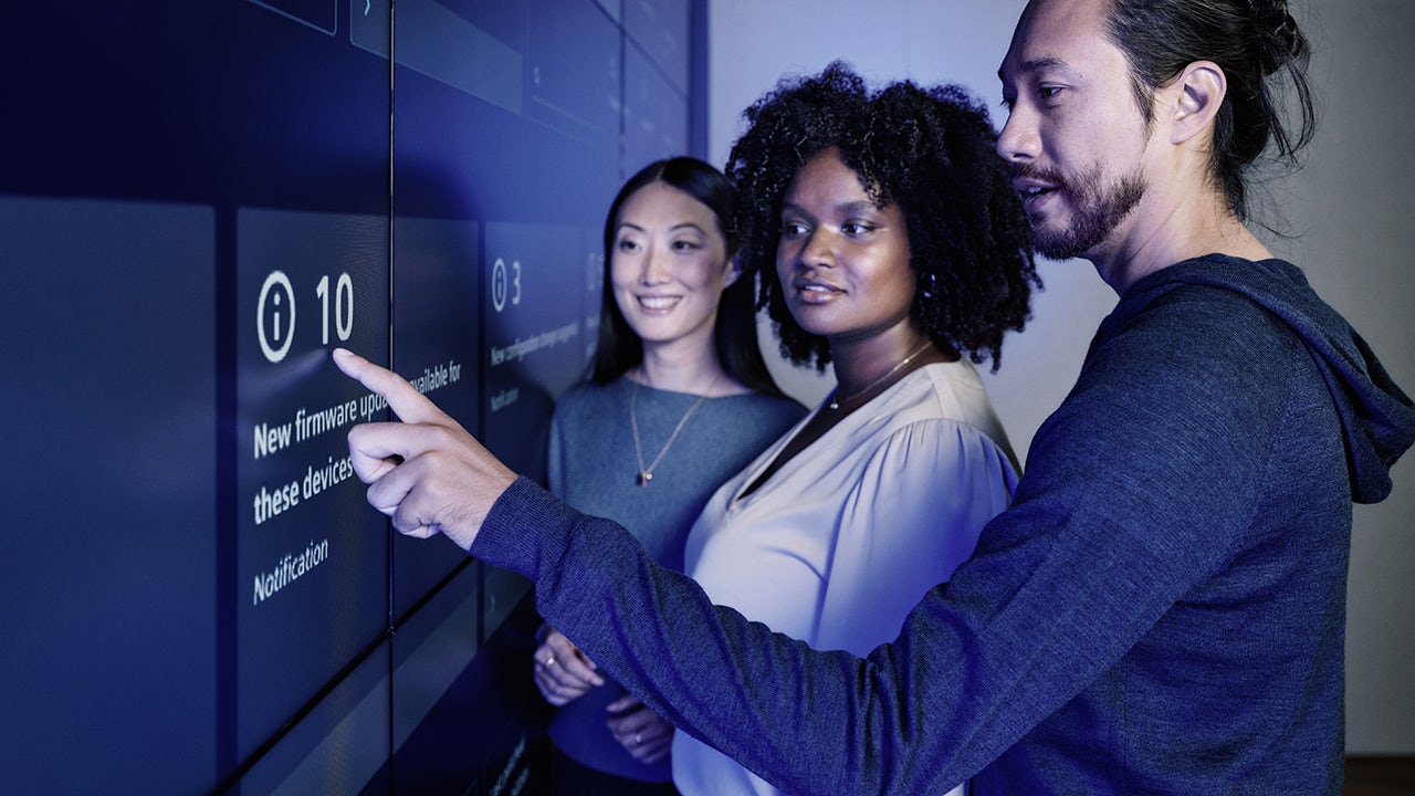 Siemens Partners Xcelerator Ecosystem event with people in business attire standing in front of a large screen.