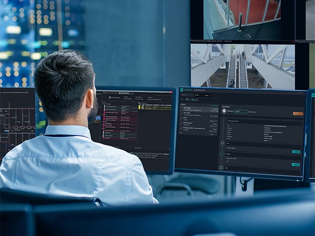 A promotional image for a Siemens security integration whitepaper featuring a modern building with a blue sky and clouds.