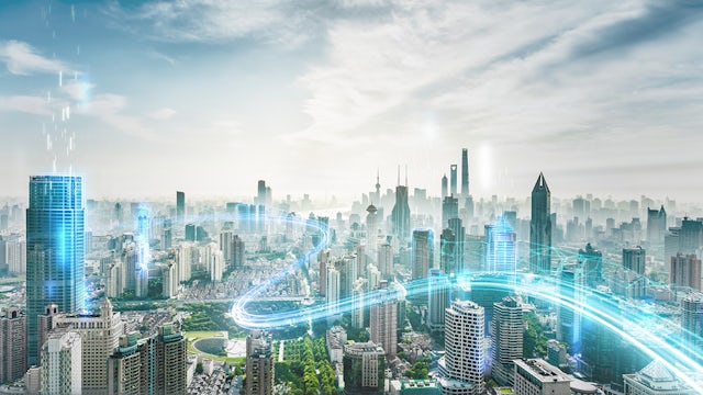A green pathway leads to a sleek, futuristic building with a modern city skyline in the distance.