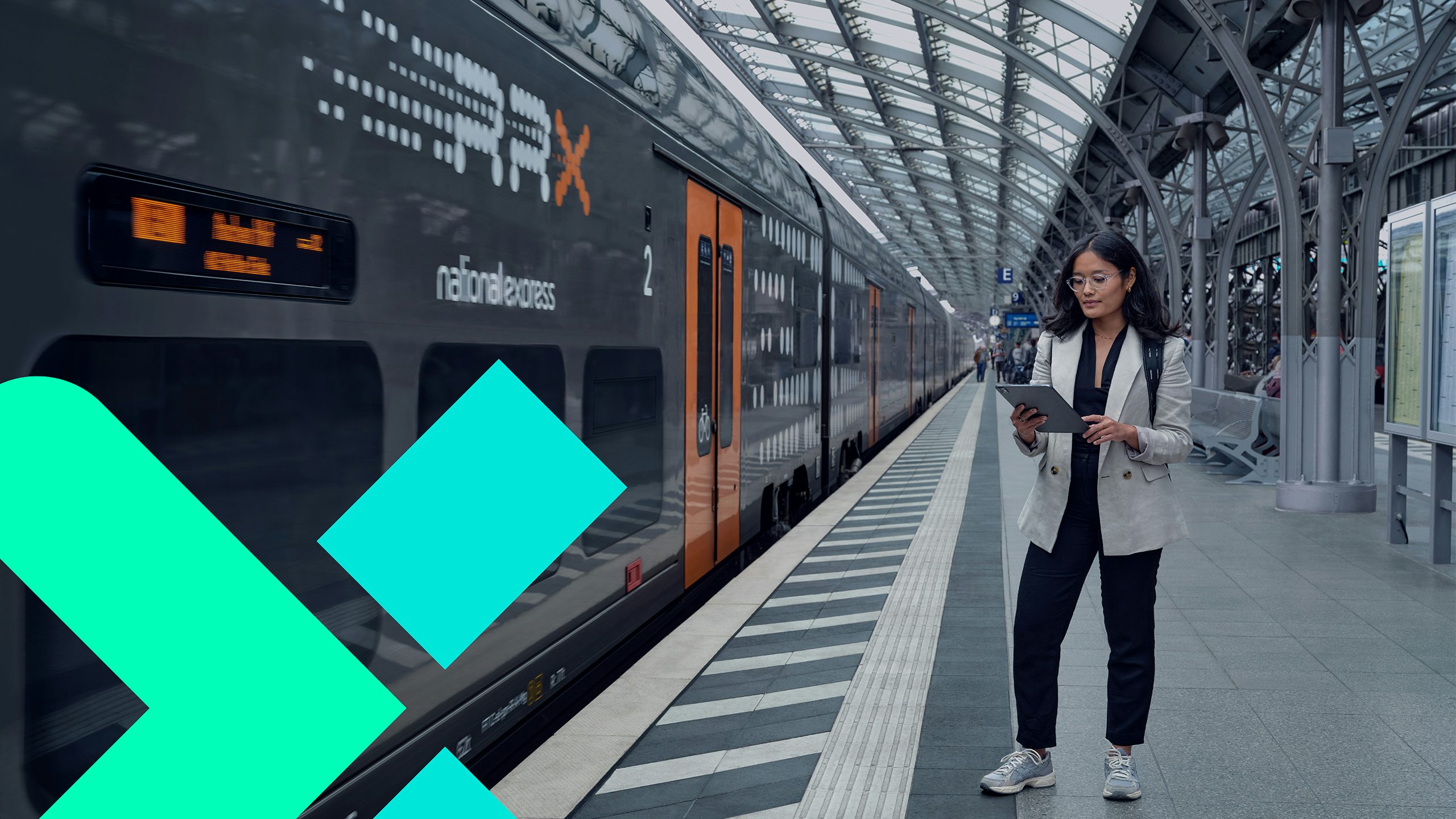 High-speed train on tracks with mountains in background