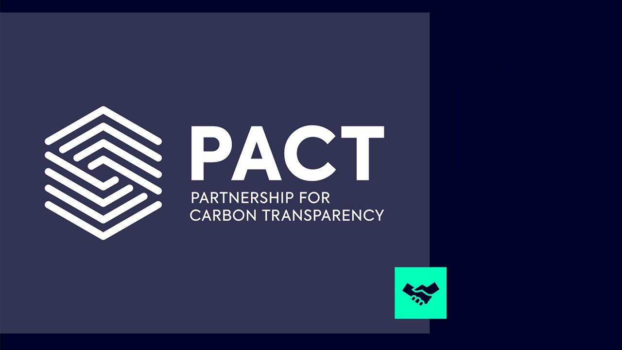 Person standing before screen with compatibility question, building and logo in background