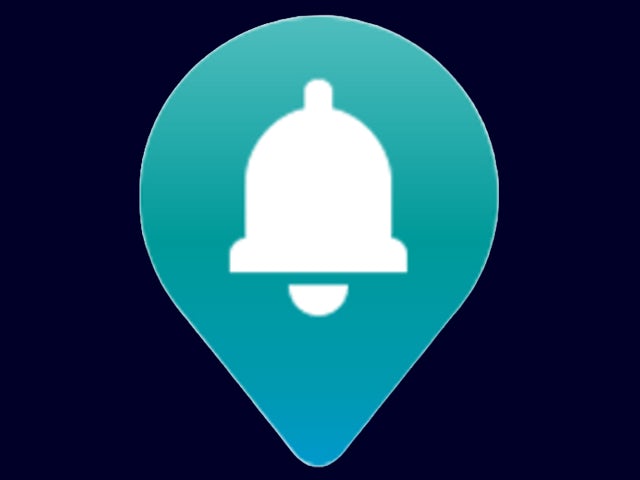 Hand holding smartphone displaying industrial monitoring app interface with gauges and alerts