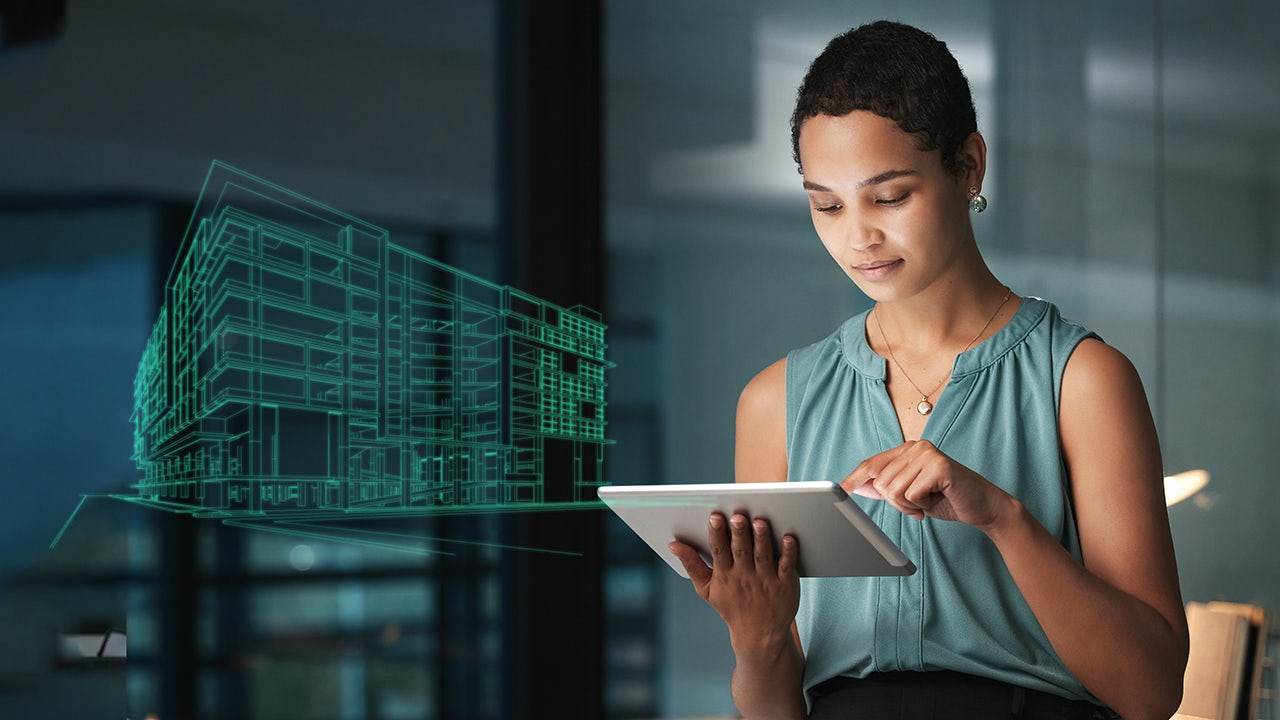 A city street with smart infrastructure and a person walking on the sidewalk.