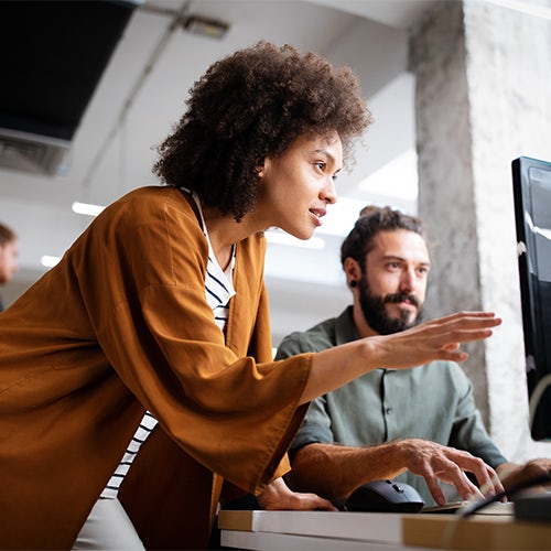 Programmers cooperating at IT company developing apps.