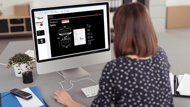 Engineer sitting behind a computer creating a technical document from a 3D model in Solid Edge.