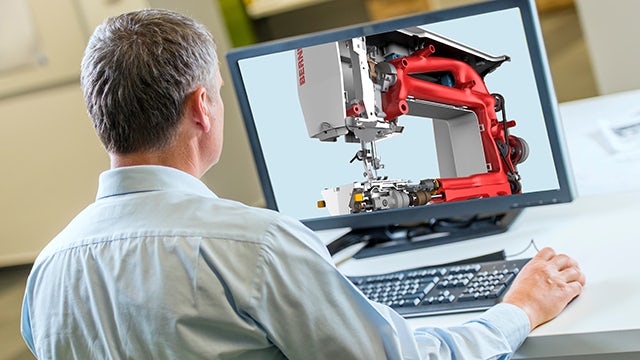 Engineer sitting behind a computer reviewing a photo-realistic rendering.