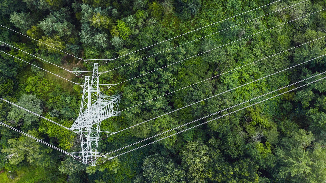 Overhead view of a transmission tower with power lines.
