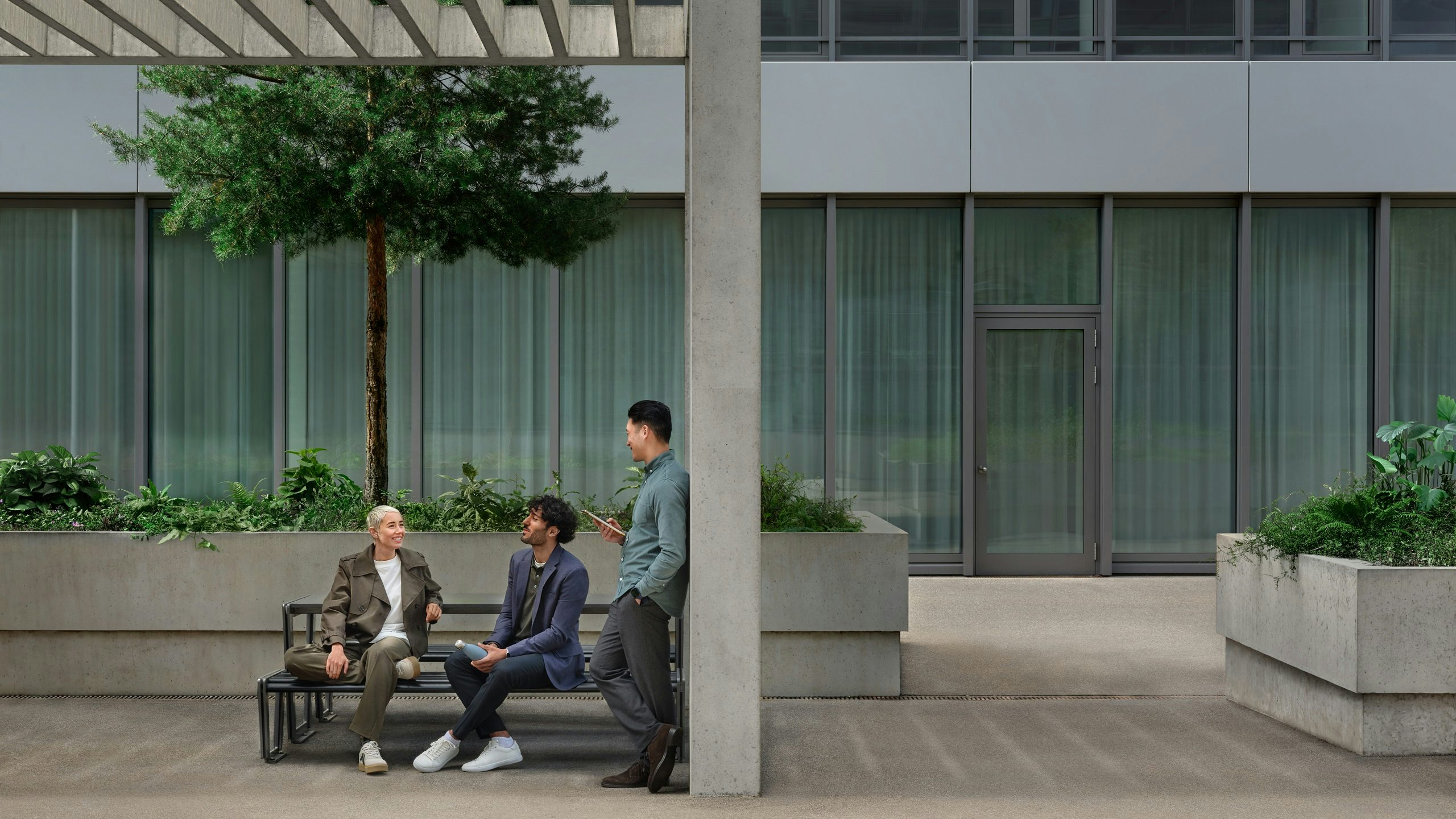 Young people in green environment and officebuilding