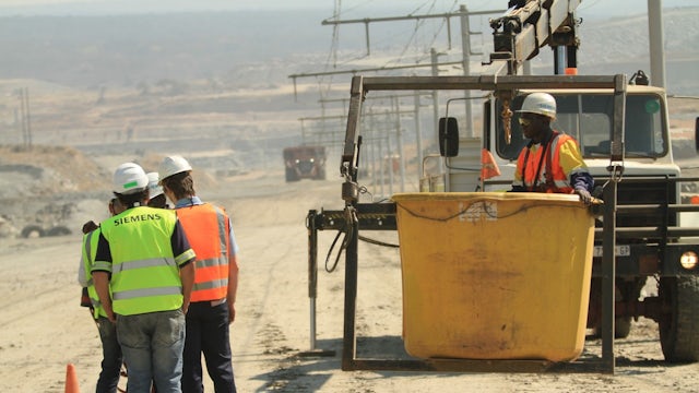 People working on power lines wearing Siemens PPE.