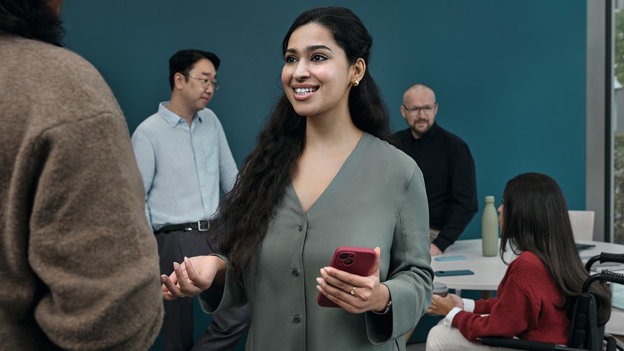 The image shows a person standing in front of a whiteboard with a diagram and text.
