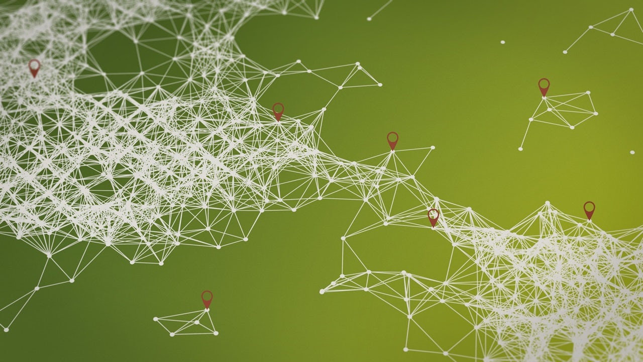 A person is standing in front of a whiteboard with a presentation slide displayed on it.