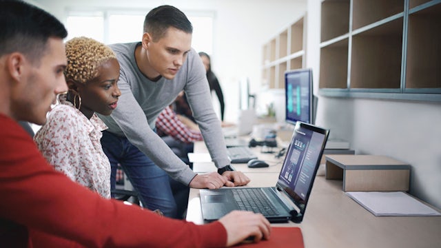 A visual representation of IT and OT integration with a cluster of interconnected nodes and data flow. 