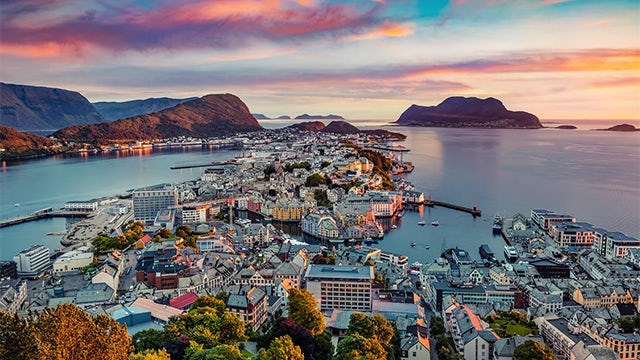 Person standing before building with signs about carbon neutrality and capital potential