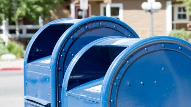 Blue metal mail collection containers.