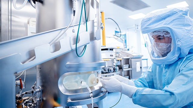 Pharmaceutical employee at BioNTech working with vaccine technology.