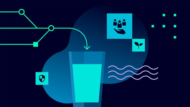 Industrial water treatment facility with large cylindrical tanks and pipes against a blue sky