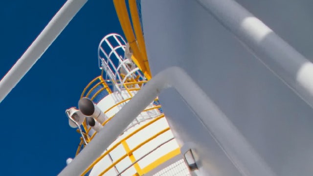 A white paper cover featuring a person in a suit and tie with a background of an oil rig and a gas pipeline.
