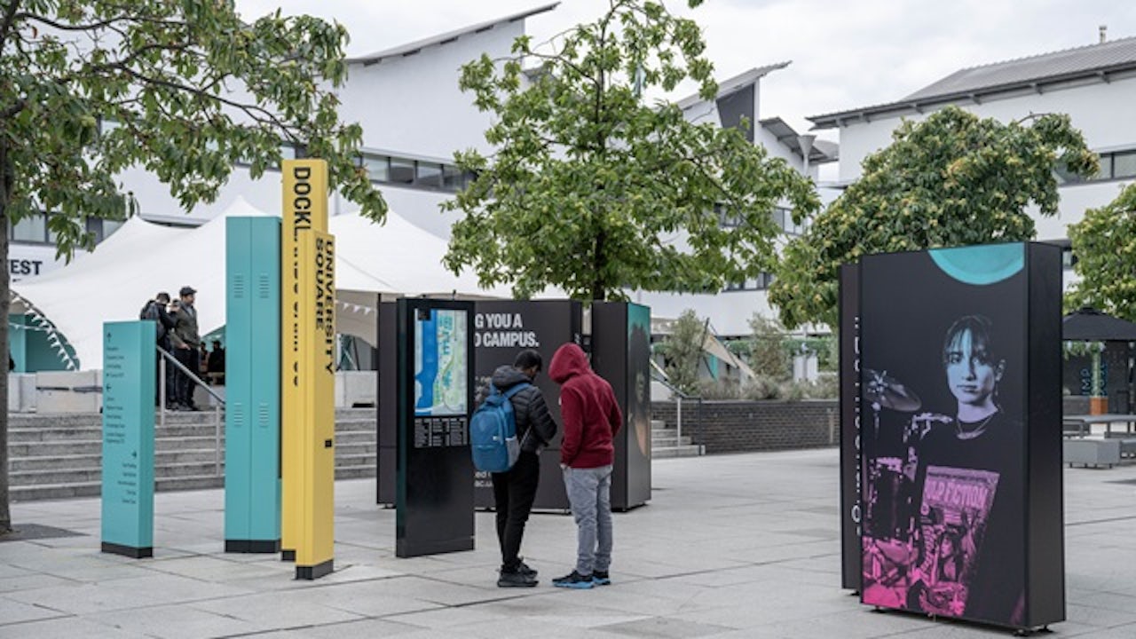 Two University of East London students talking in University Square.
