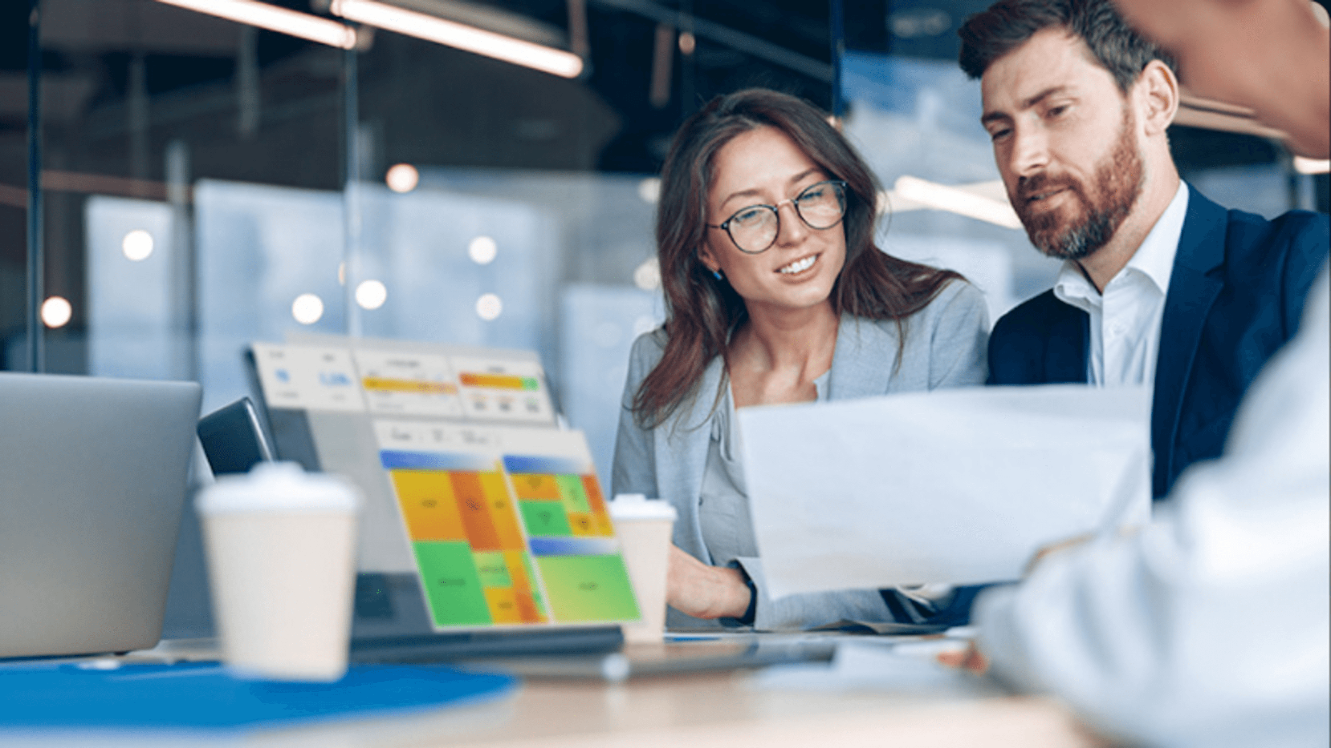 Two people reviewing documents in office